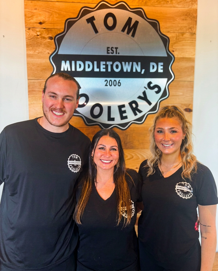 The Tom Foolery's team in front of our Middletown, DE logo